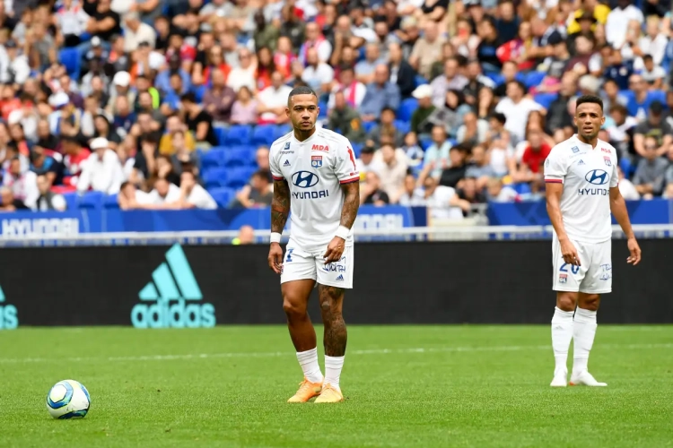 Déçu par son équipe, un supporter lyonnais regarde un autre match sur son portable